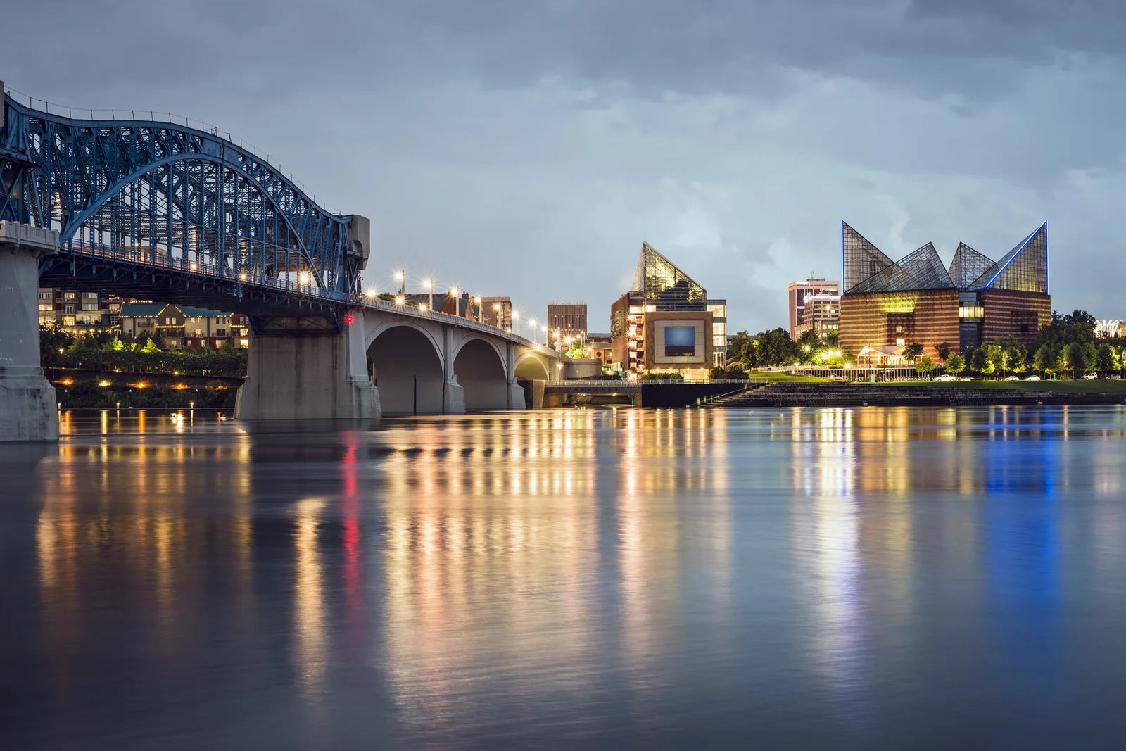 Market Street Bridge and city skyline along the Tennessee River in Chattanooga at dusk.