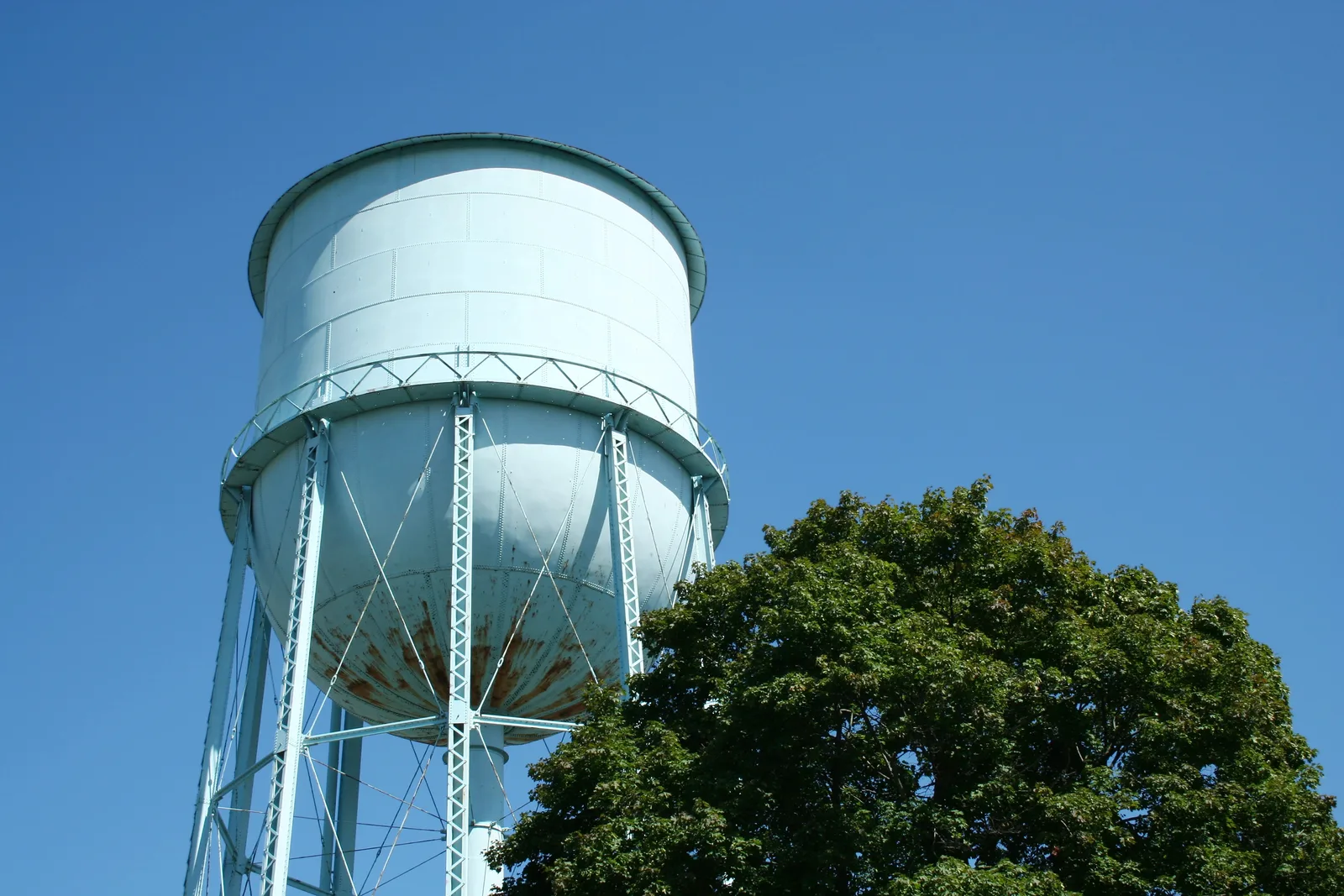 A municipal water tower against a clear blue sky.