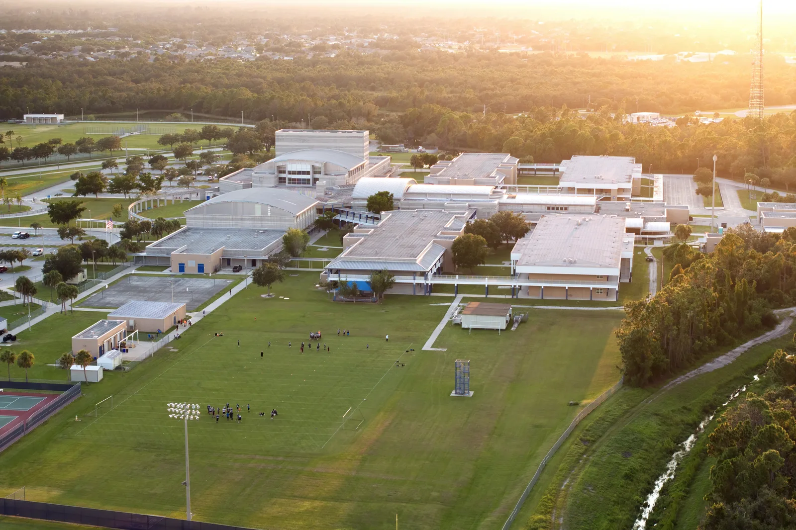 Aerial view of a multi-building complex and athletic fields.