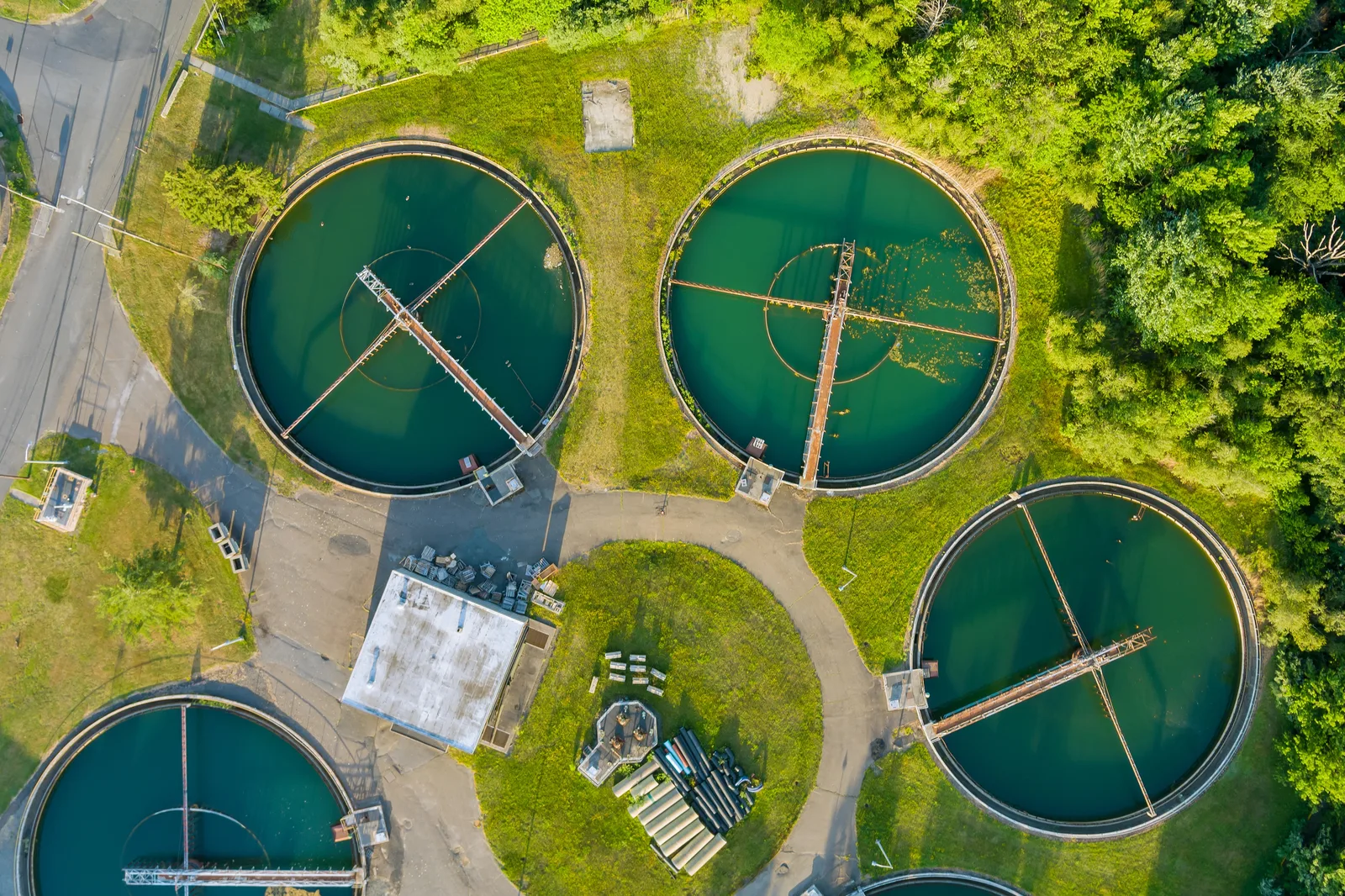 Aerial view of circular clarifier tanks at a water treatment facility.