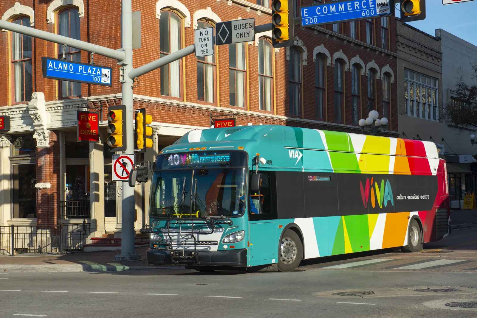A VIA transit bus navigating downtown San Antonio.