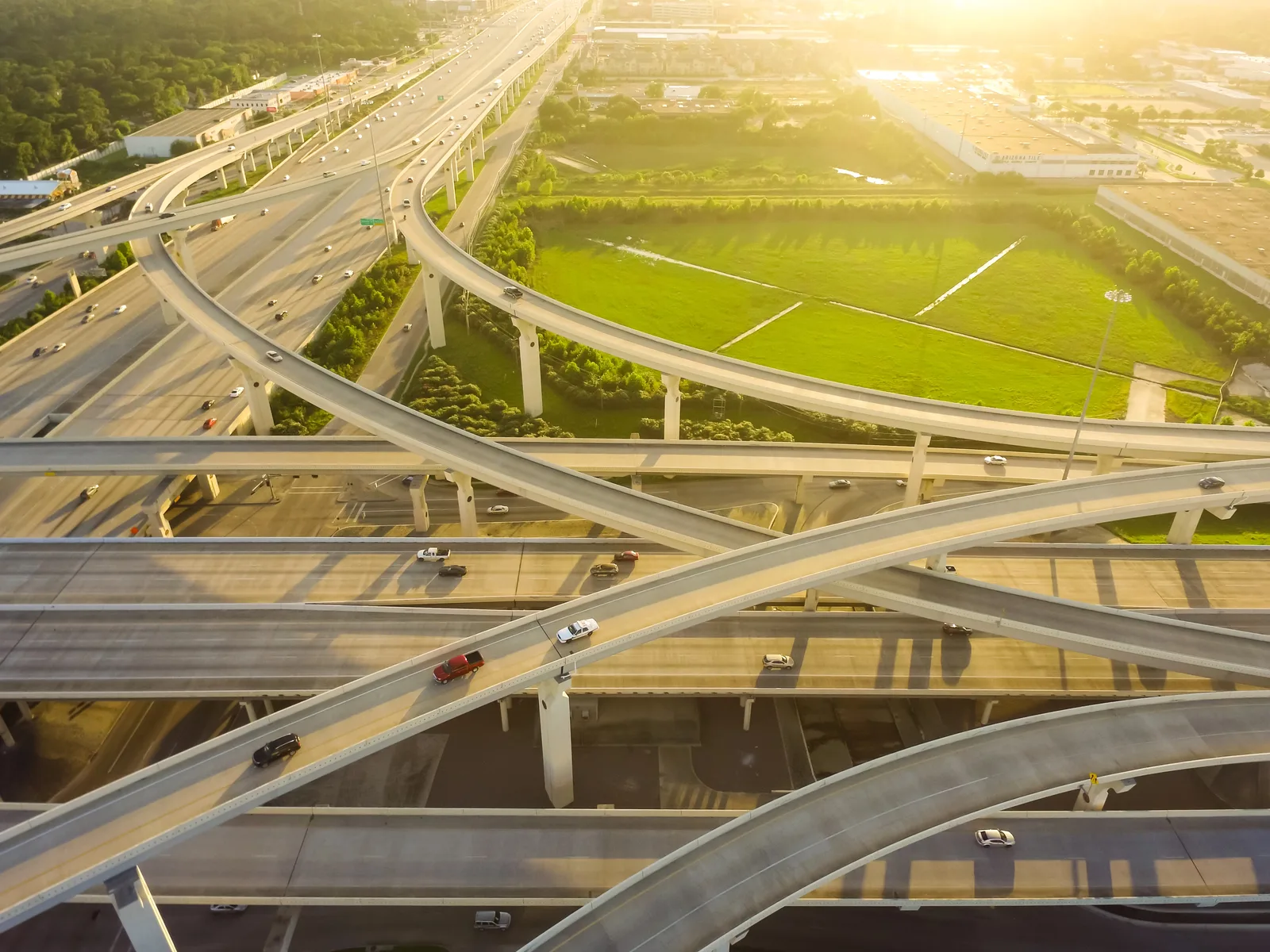 Aerial view of a multi-level highway interchange at golden hour.