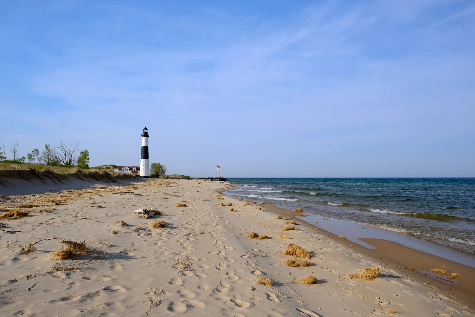 A Great Lakes shoreline and lighthouse representing regional water utility infrastructure.